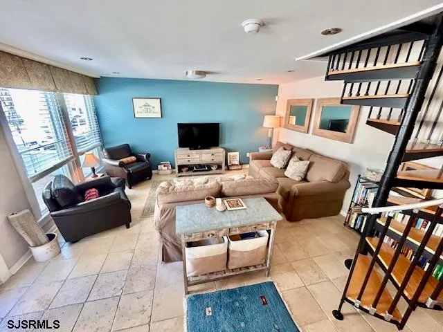 a living room with furniture and a flat screen tv