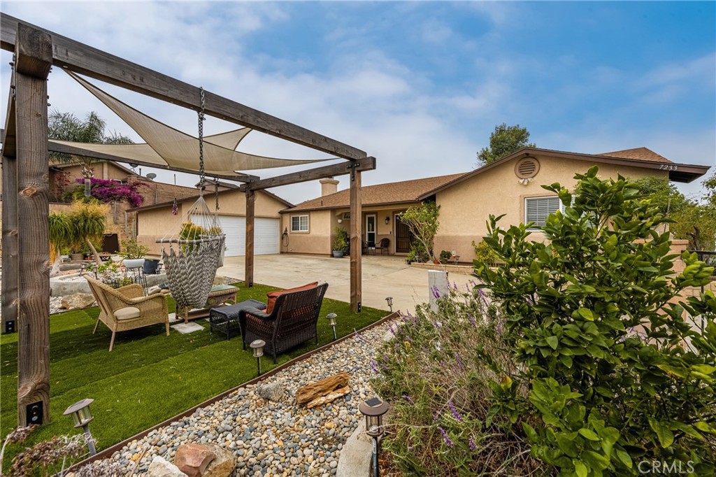 7233 Bel Air Street Corona, CA 92881 - Photo 11 of 39 a view of a patio with table and chairs under an umbrella