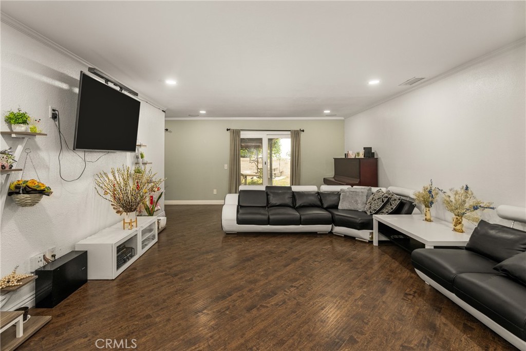 7233 Bel Air Street Corona, CA 92881 - Photo 17 of 39 a living room with furniture and a flat screen tv