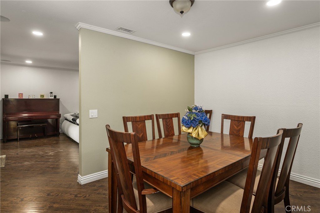 7233 Bel Air Street Corona, CA 92881 - Photo 29 of 39 a view of a dining room with furniture and wooden floor