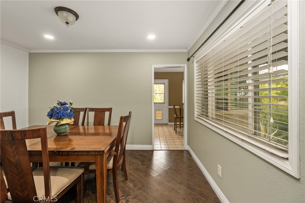 7233 Bel Air Street Corona, CA 92881 - Photo 30 of 39 a view of a dining room with furniture window and wooden floor