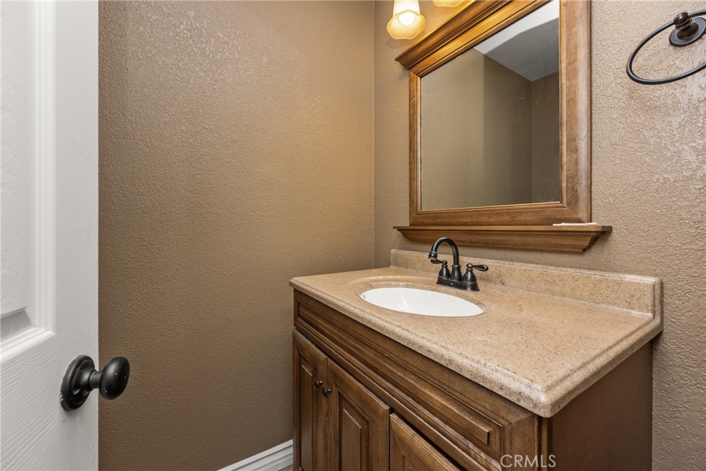 7233 Bel Air Street Corona, CA 92881 - Photo 32 of 39 a bathroom with a sink and a mirror