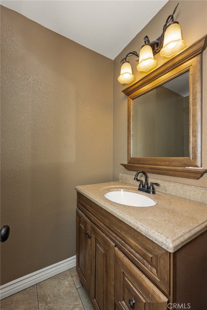 7233 Bel Air Street Corona, CA 92881 - Photo 33 of 39 a bathroom with a sink and a mirror