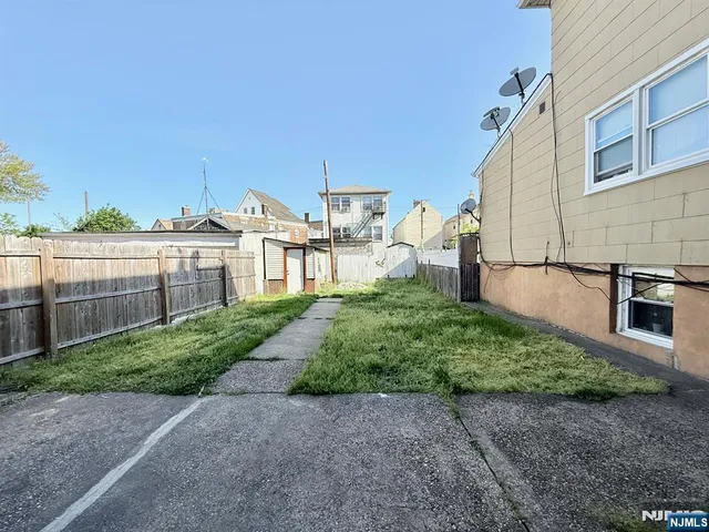a view of a backyard with sitting area