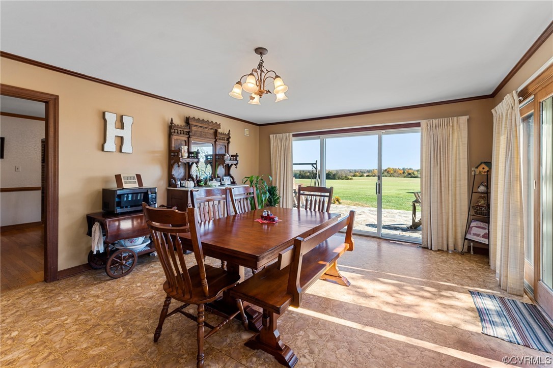 11221 Bristersburg Road Catlett, VA 20119 - Photo 35 of 49 a dining room with furniture a rug and a chandelier