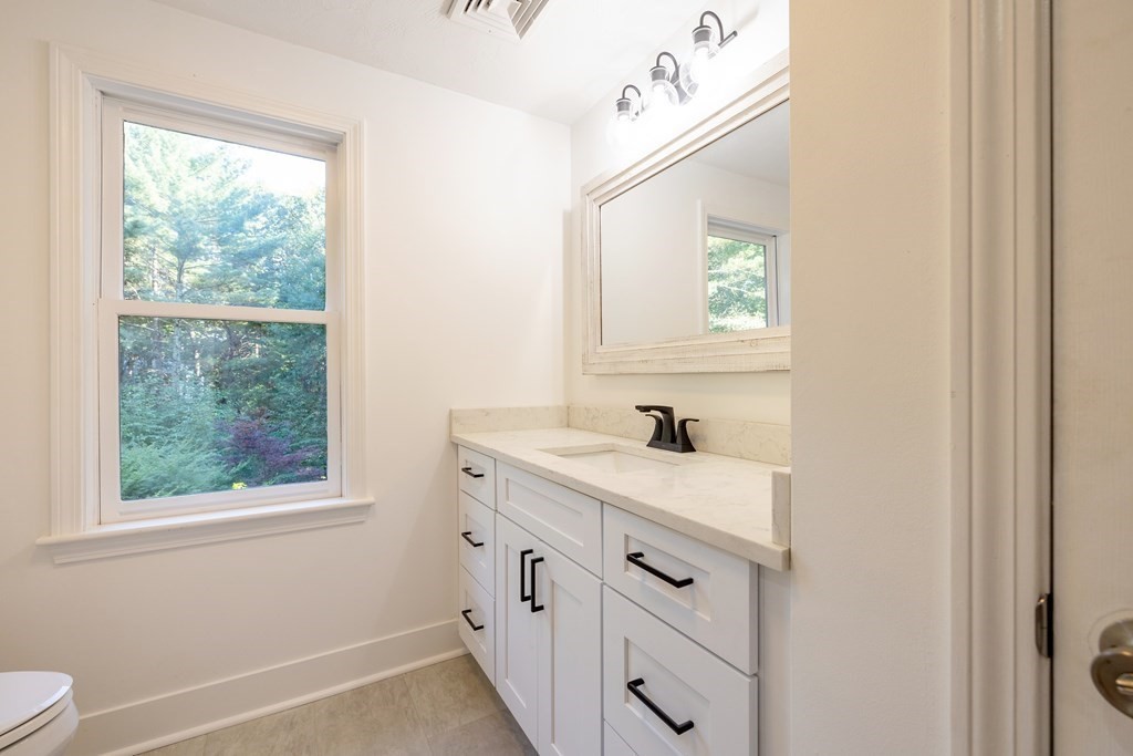 66 Patten Road Westford, MA 01886 - Photo 17 of 42 a bathroom with a sink a vanity a window and a mirror