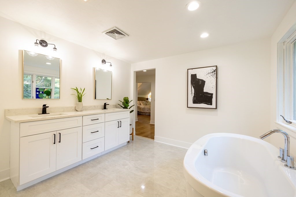 66 Patten Road Westford, MA 01886 - Photo 23 of 42 a spacious bathroom with a double vanity sink mirror and bathtub