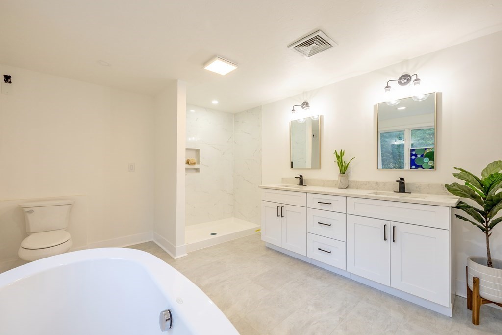 66 Patten Road Westford, MA 01886 - Photo 24 of 42 a spacious bathroom with a granite countertop sink mirror and toilet