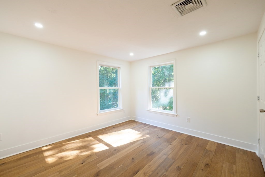 66 Patten Road Westford, MA 01886 - Photo 29 of 42 an empty room with wooden floor and windows