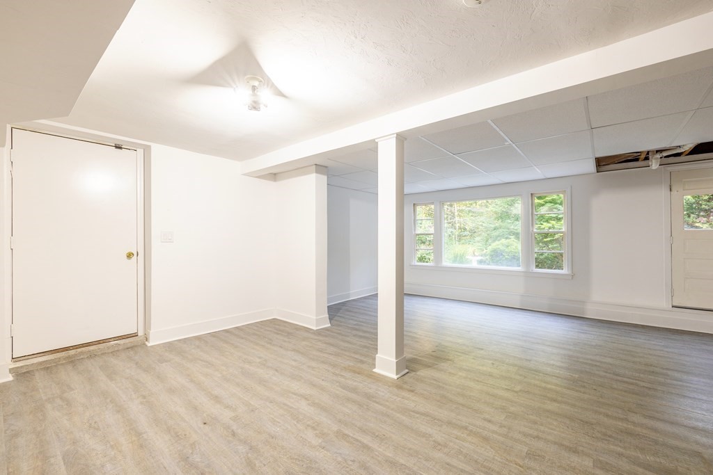 66 Patten Road Westford, MA 01886 - Photo 32 of 42 an empty room with wooden floor and windows