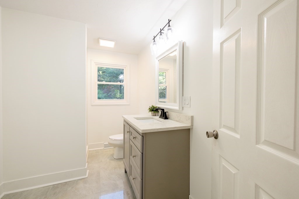 66 Patten Road Westford, MA 01886 - Photo 33 of 42 a bathroom with a sink a toilet and a mirror