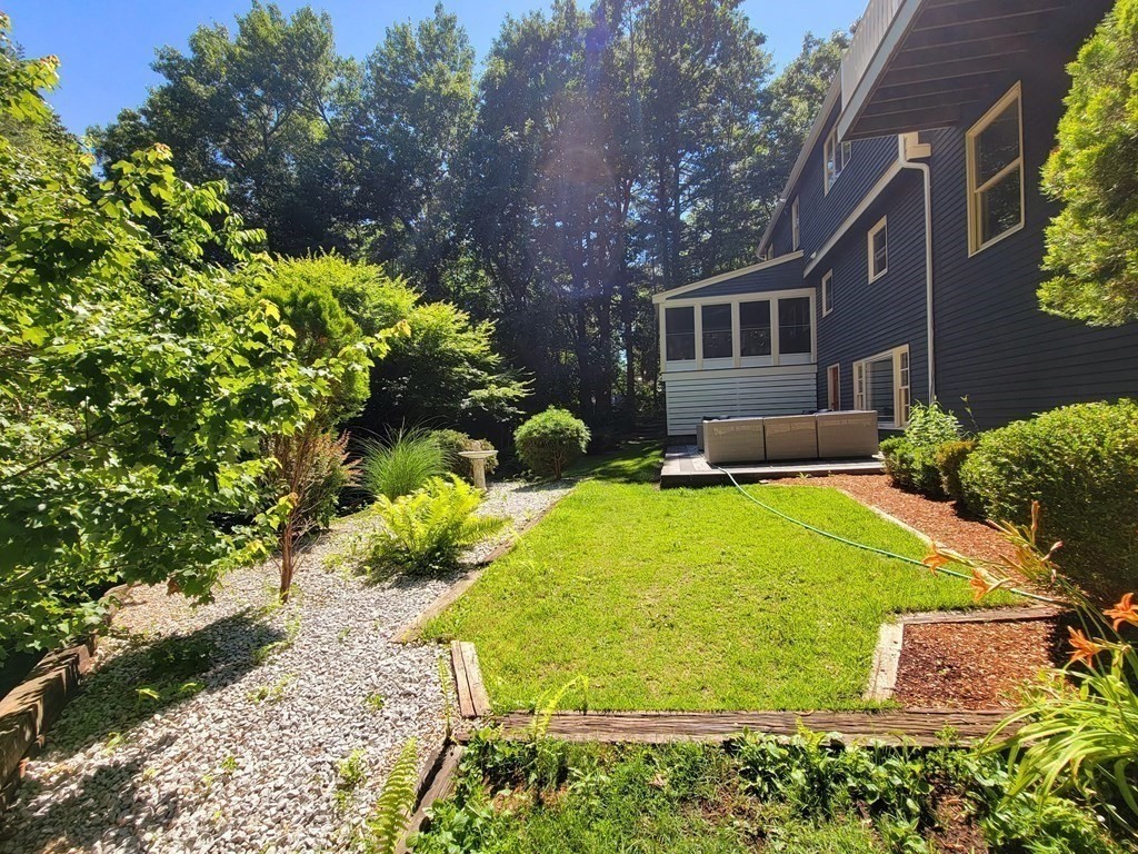 66 Patten Road Westford, MA 01886 - Photo 40 of 42 a view of a house with a yard and sitting area
