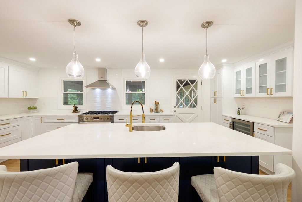 66 Patten Road Westford, MA 01886 - Photo 6 of 42 a kitchen with stainless steel appliances kitchen island granite countertop a sink a stove and white cabinets