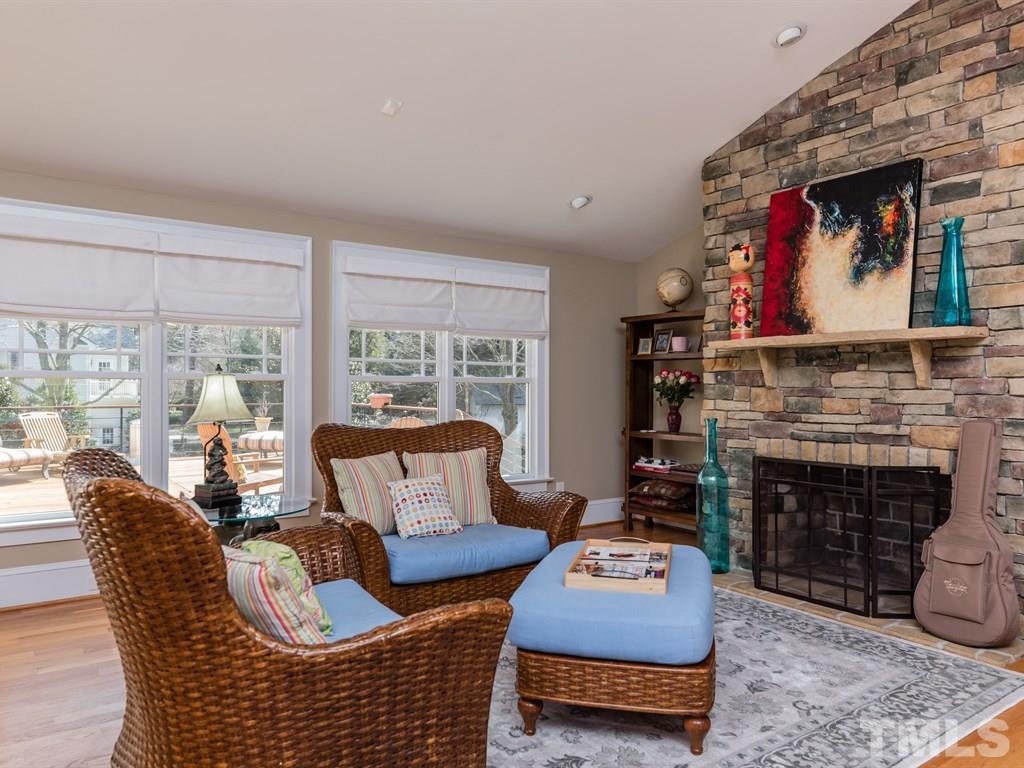 1910 Highland Place Raleigh, NC 27607 - Photo 11 of 25 a living room with furniture a rug a fireplace and a large window