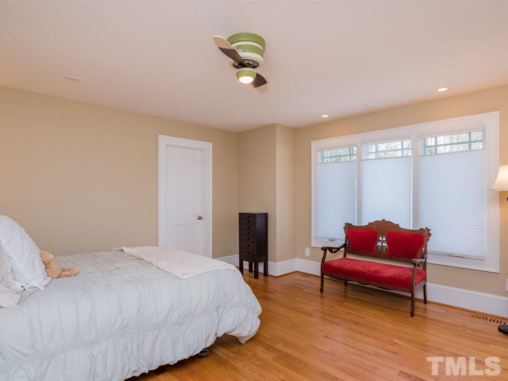 1910 Highland Place Raleigh, NC 27607 - Photo 19 of 25 a bedroom with a bed and wooden floor