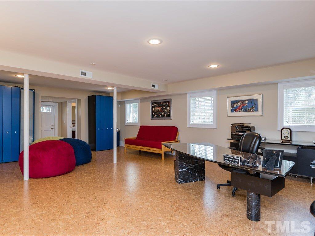 1910 Highland Place Raleigh, NC 27607 - Photo 20 of 25 a living room with furniture and a wooden floor