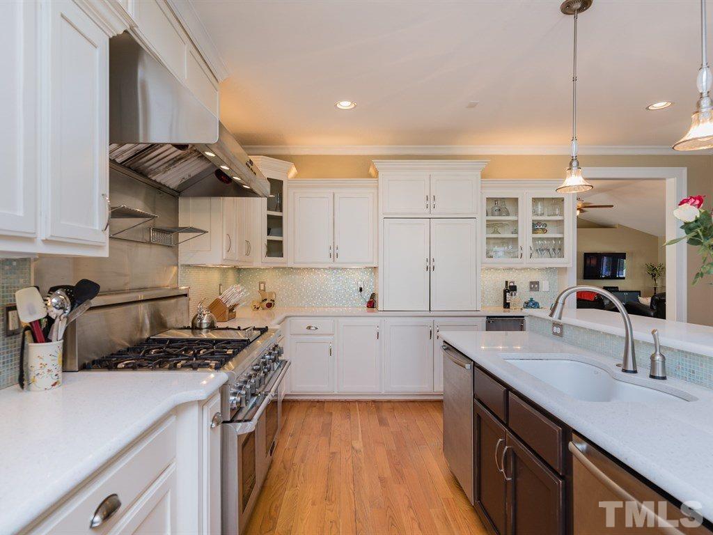 1910 Highland Place Raleigh, NC 27607 - Photo 7 of 25 a kitchen with a sink a stove and cabinets