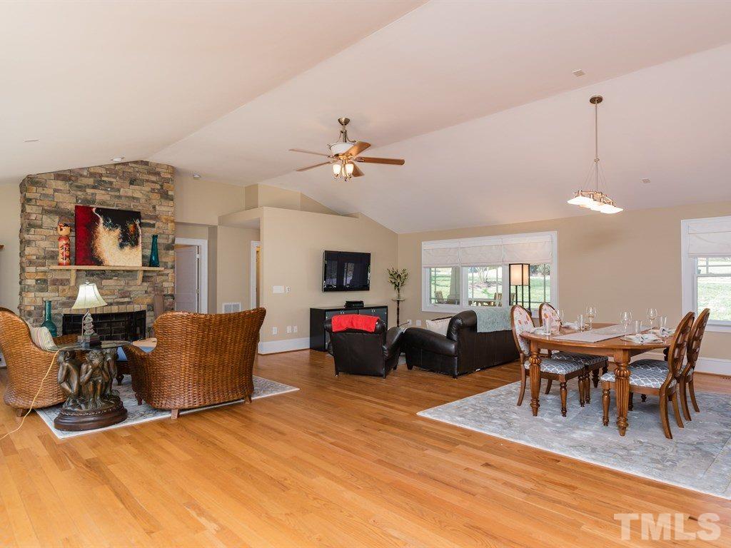 1910 Highland Place Raleigh, NC 27607 - Photo 10 of 25 a living room with furniture a fireplace and a chandelier