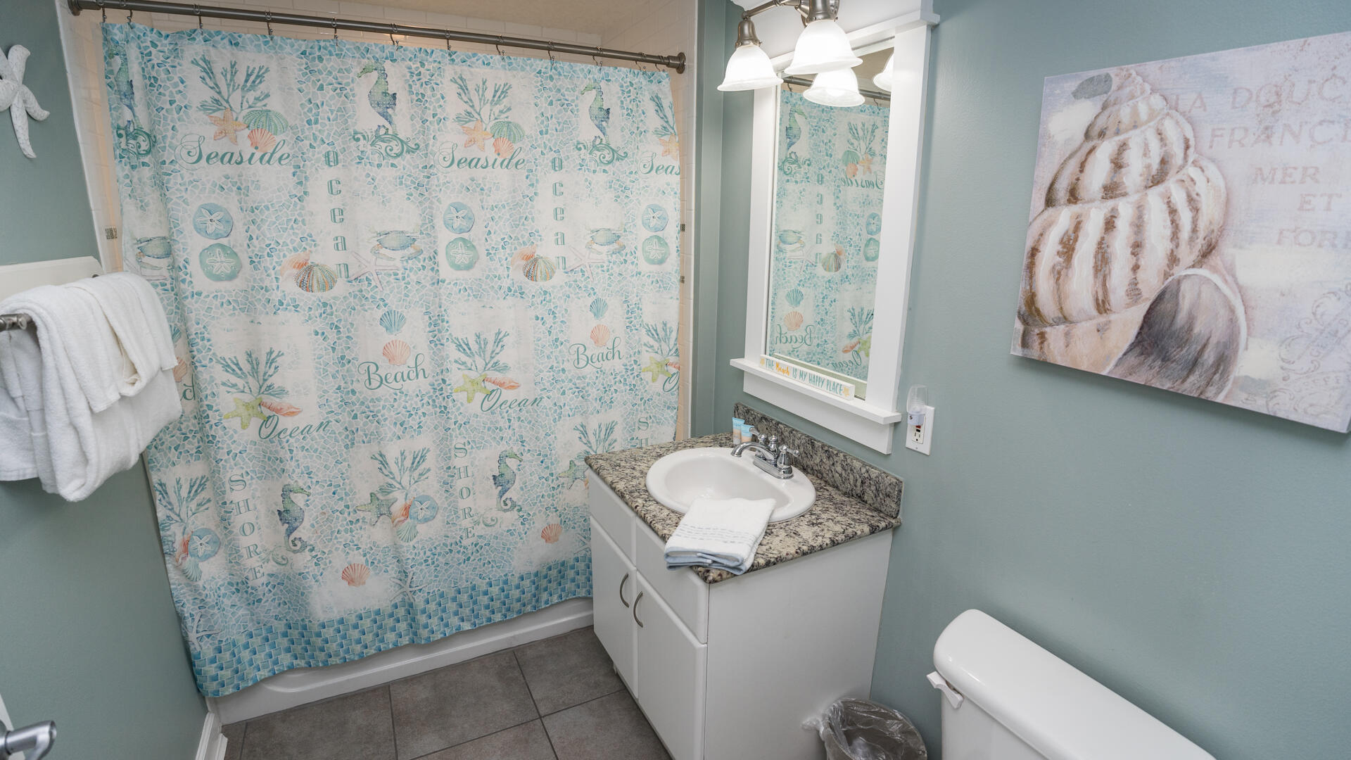 11800 Front Beach Road, Unit 703 Panama City Beach, FL 32407 - Photo 12 of 52 a bathroom with a sink a toilet and shower curtain