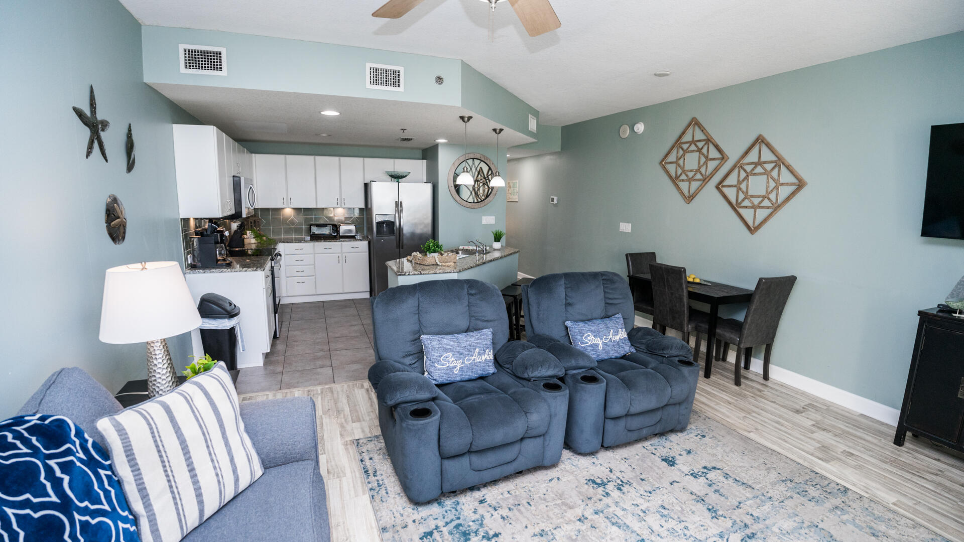 11800 Front Beach Road, Unit 703 Panama City Beach, FL 32407 - Photo 16 of 52 a living room with furniture kitchen view and a wooden floor