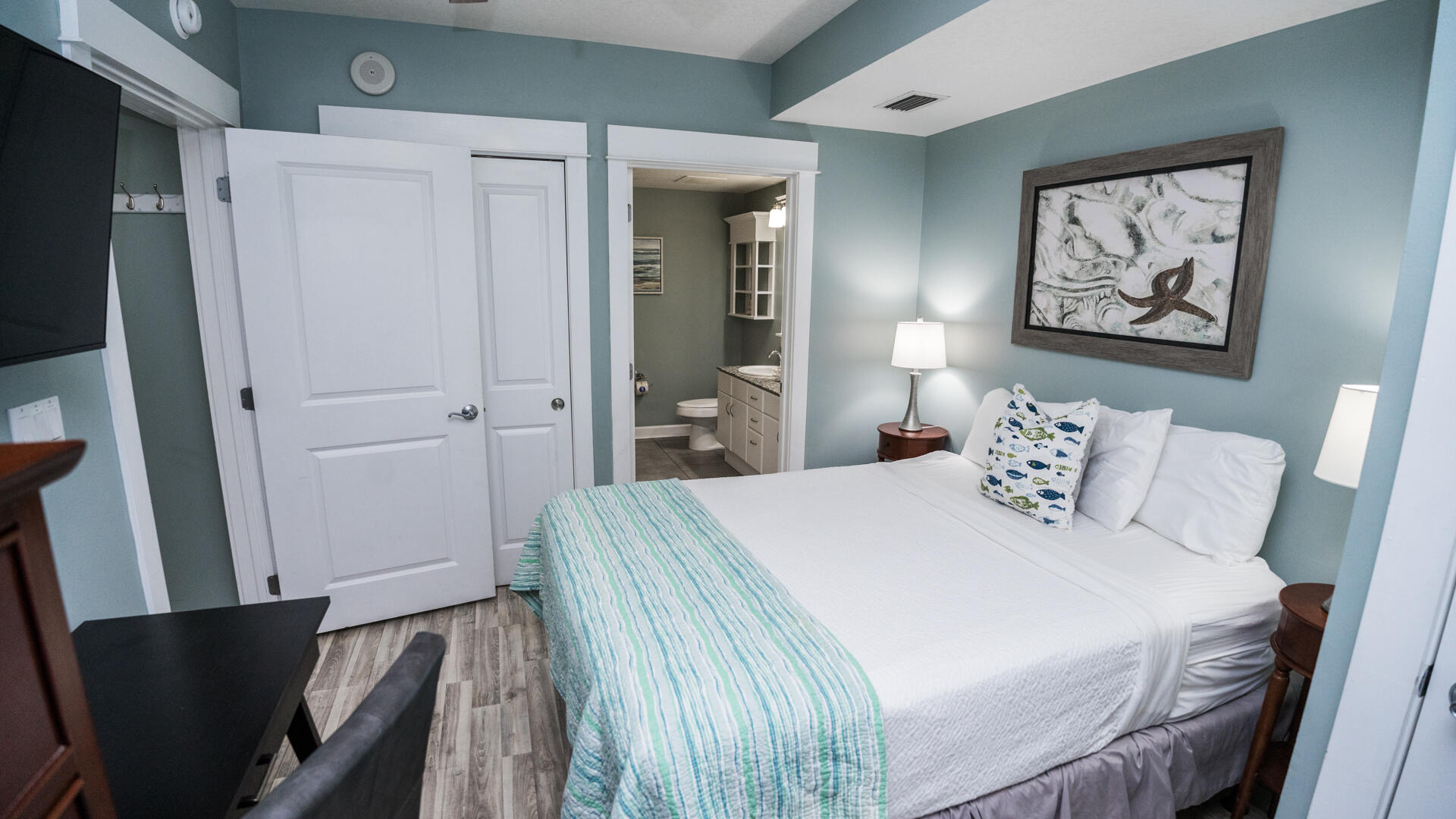 11800 Front Beach Road, Unit 703 Panama City Beach, FL 32407 - Photo 2 of 52 a bedroom with a bed and a painting on the wall