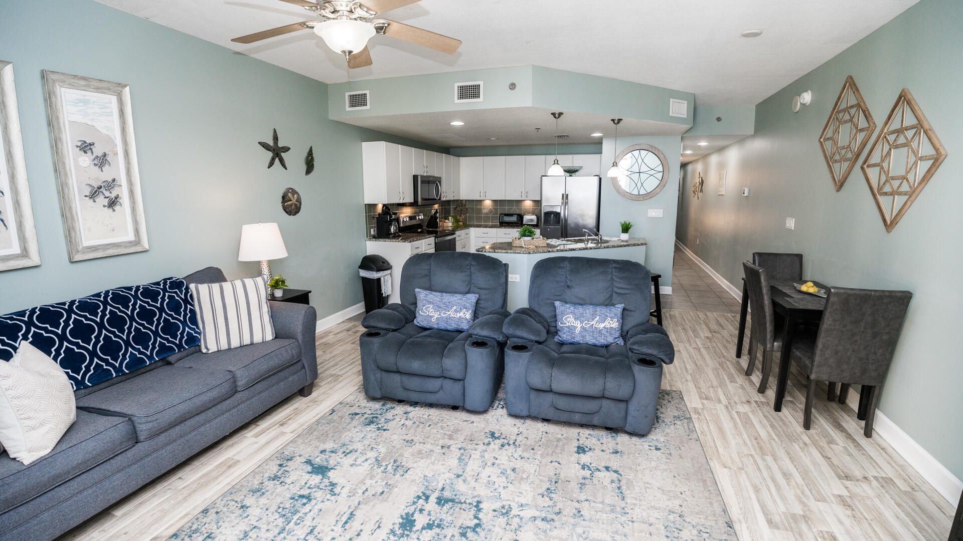 11800 Front Beach Road, Unit 703 Panama City Beach, FL 32407 - Photo 21 of 52 a living room with furniture and a chandelier