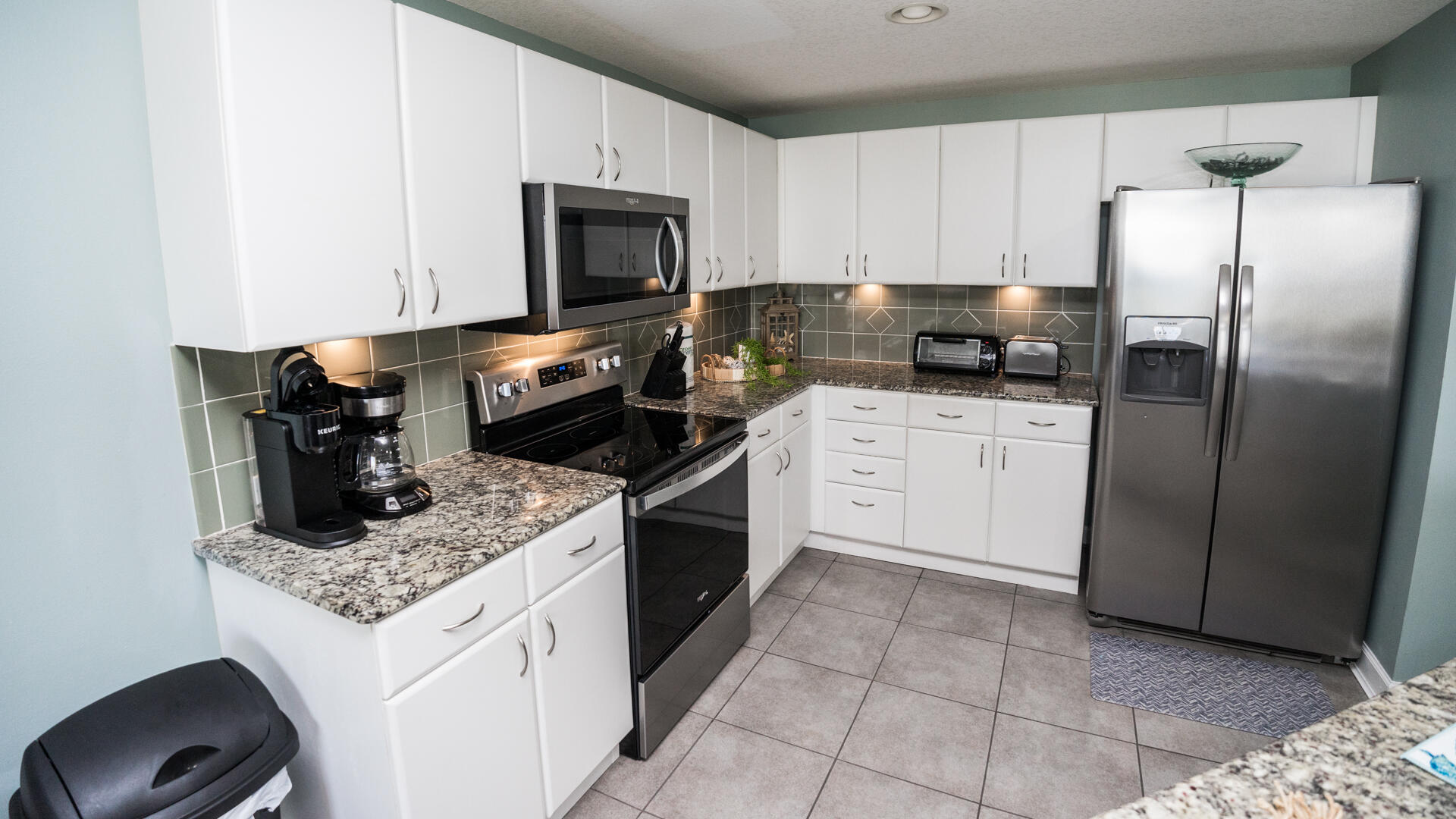 11800 Front Beach Road, Unit 703 Panama City Beach, FL 32407 - Photo 24 of 52 a kitchen with a stove microwave and refrigerator