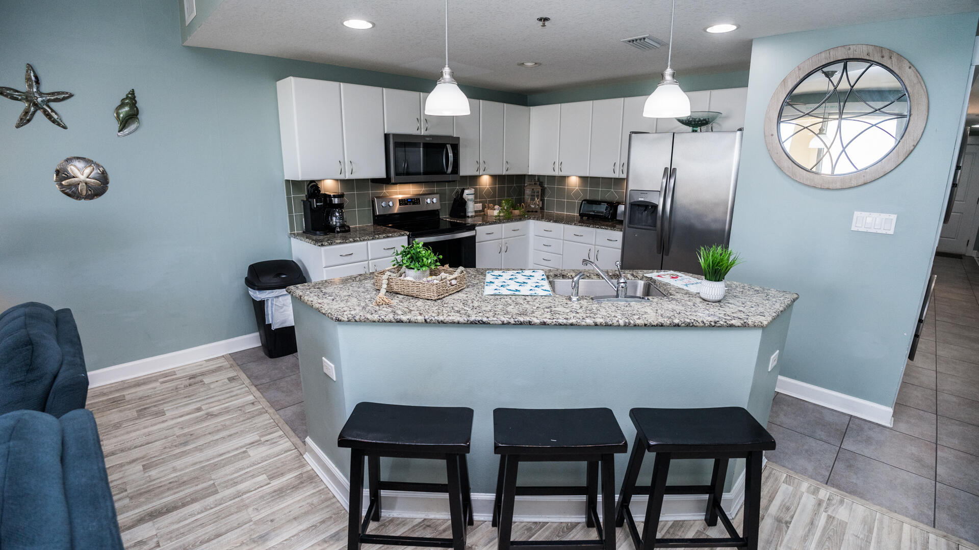 11800 Front Beach Road, Unit 703 Panama City Beach, FL 32407 - Photo 27 of 52 a view of kitchen with sink dining table and chairs