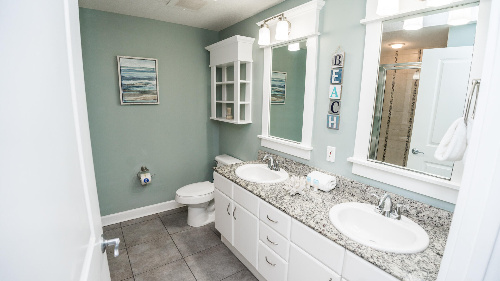 11800 Front Beach Road, Unit 703 Panama City Beach, FL 32407 - Photo 4 of 52 a bathroom with a granite countertop sink a mirror and a toilet