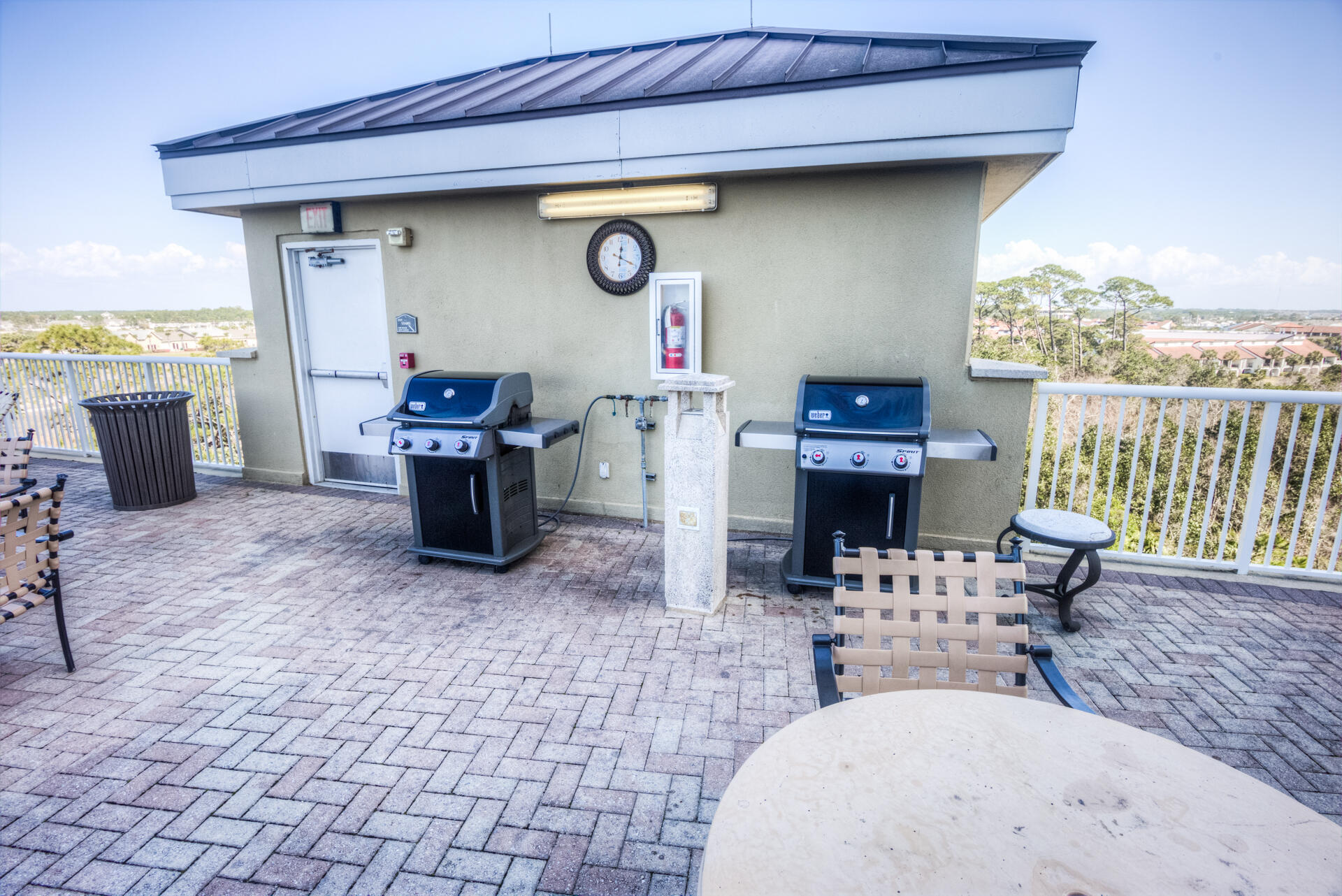 11800 Front Beach Road, Unit 703 Panama City Beach, FL 32407 - Photo 49 of 52 a view of a patio with dining table and chairs