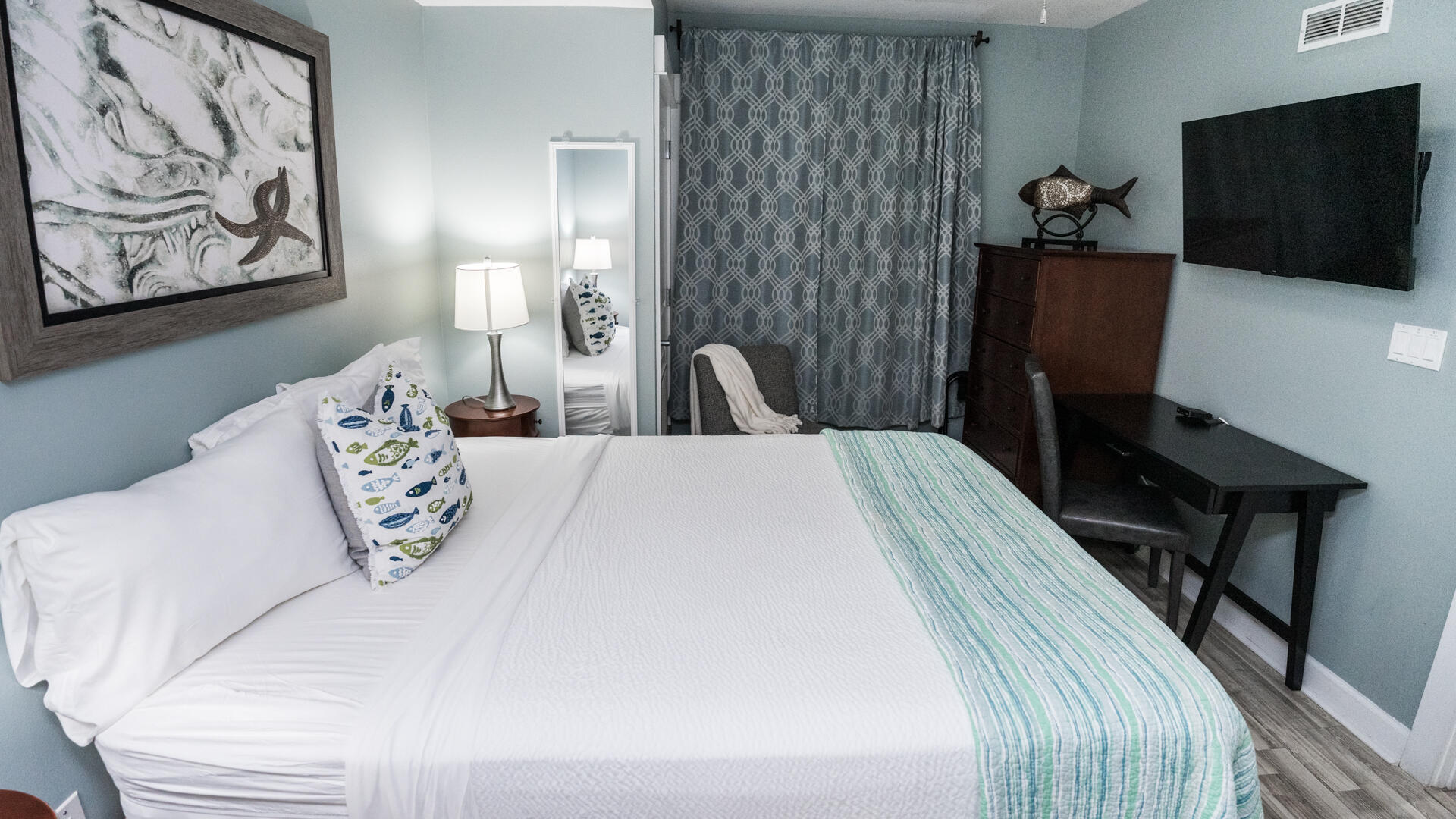 11800 Front Beach Road, Unit 703 Panama City Beach, FL 32407 - Photo 5 of 52 a bedroom with a bed and a flat screen tv