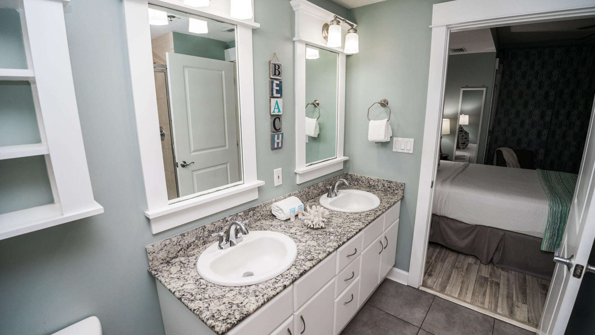 11800 Front Beach Road, Unit 703 Panama City Beach, FL 32407 - Photo 7 of 52 a en suite bathroom with a granite countertop sink and a mirror