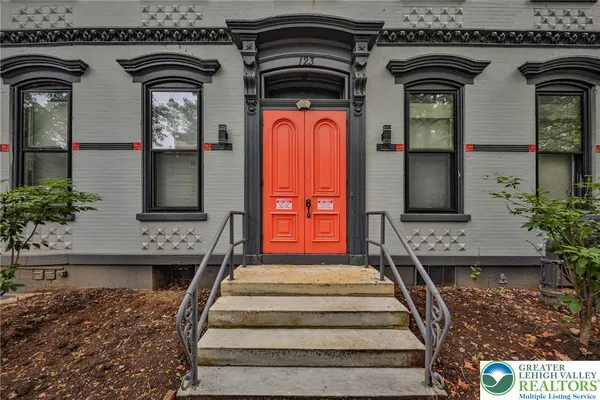 a front view of a house with a fountain