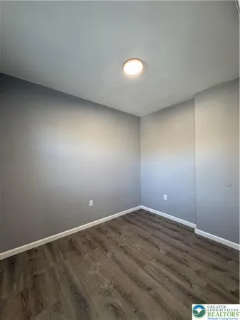 an empty room with wooden floor