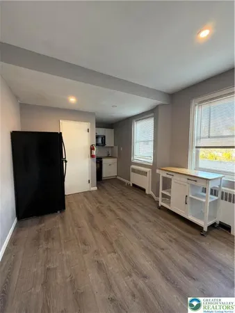 a view of a bedroom with furniture and windows