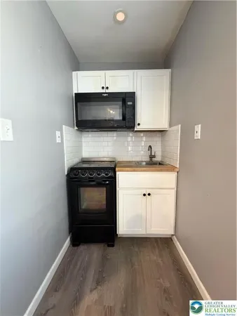 a kitchen with a sink stove and microwave