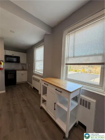 a kitchen with stainless steel appliances granite countertop a stove and a refrigerator