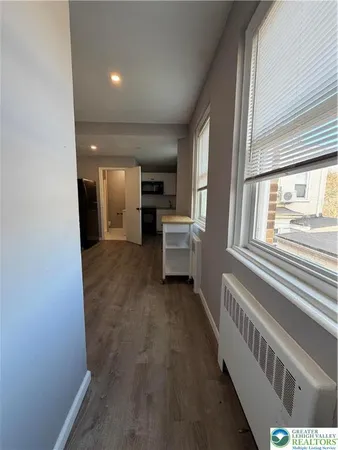 a view of a hallway with a kitchen