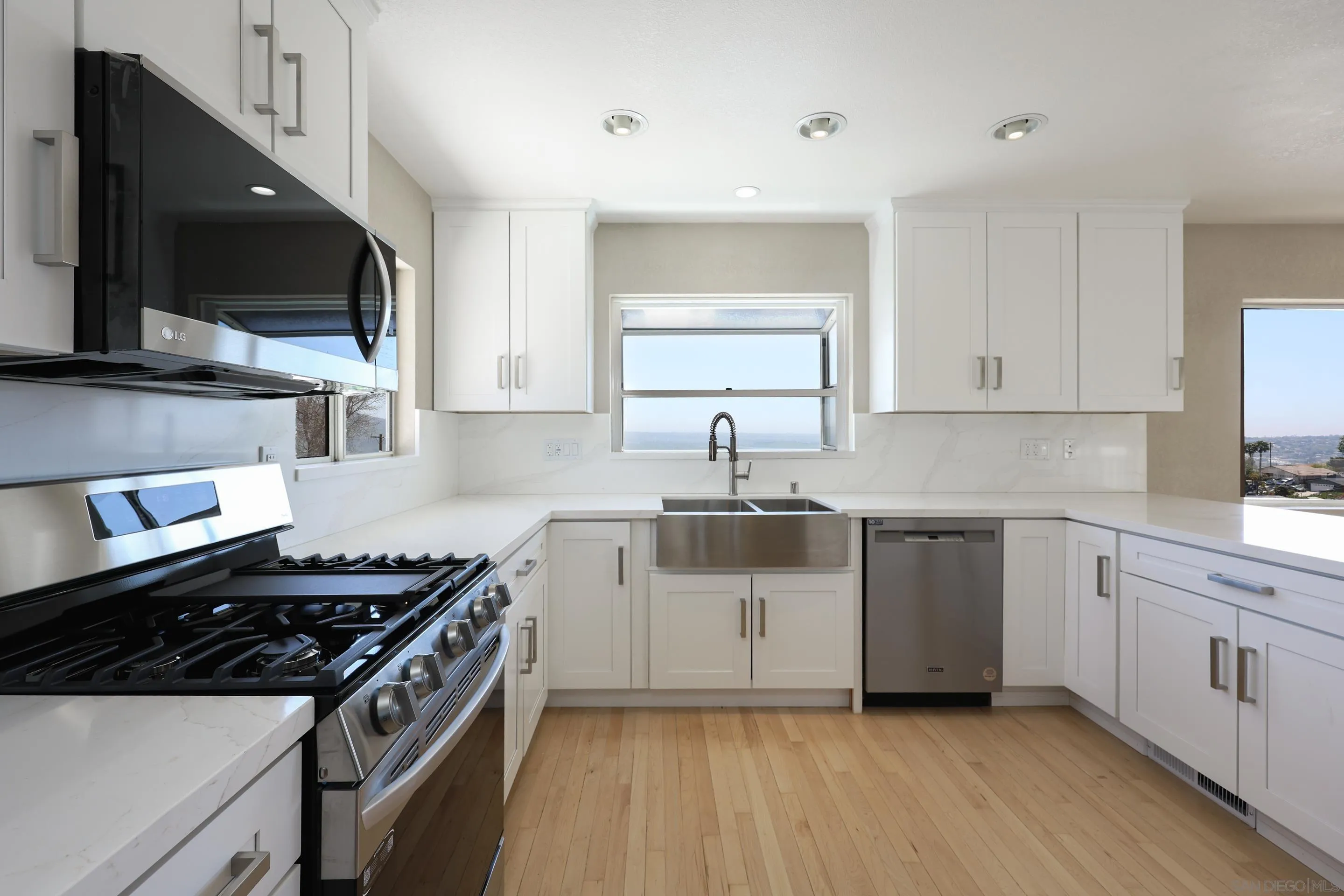 1412 San Miguel Avenue Spring Valley, CA 91977 - Photo 12 of 44 a kitchen with stainless steel appliances a sink dishwasher a stove and a microwave oven on cabinets