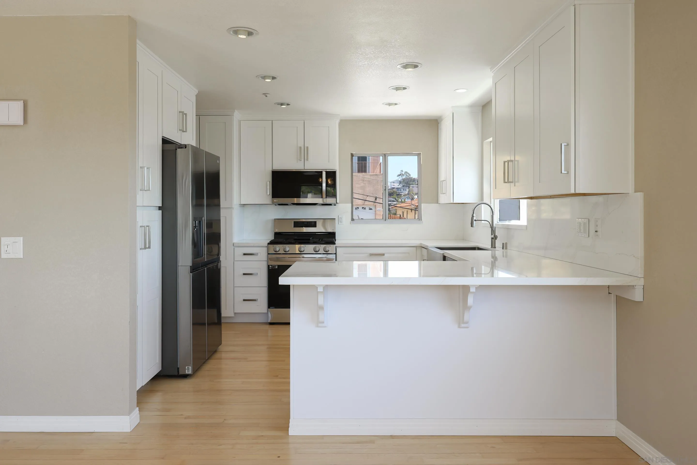 1412 San Miguel Avenue Spring Valley, CA 91977 - Photo 13 of 44 a kitchen with stainless steel appliances a sink a stove a refrigerator and cabinets