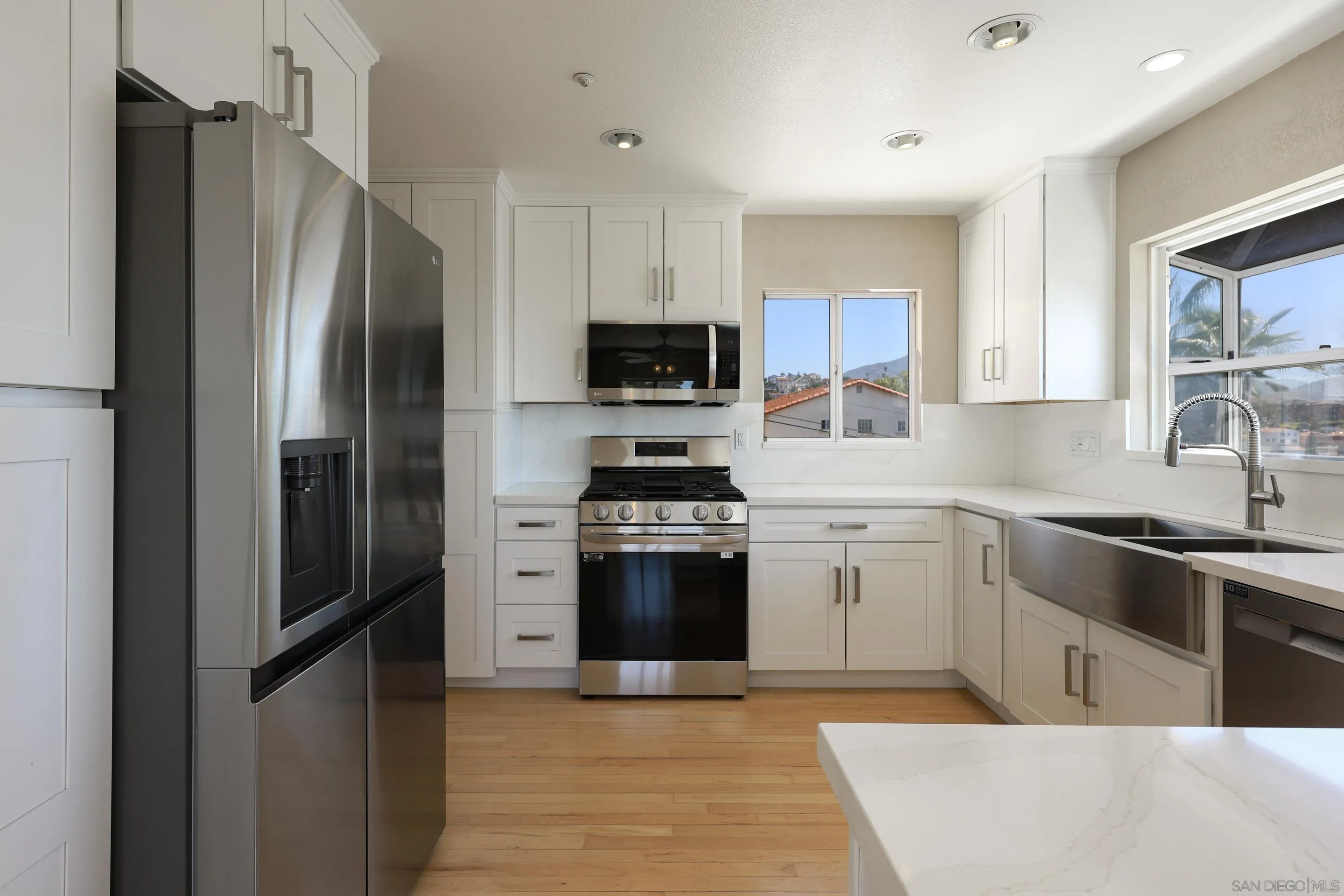 1412 San Miguel Avenue Spring Valley, CA 91977 - Photo 14 of 44 a kitchen with stainless steel appliances granite countertop a refrigerator stove and sink