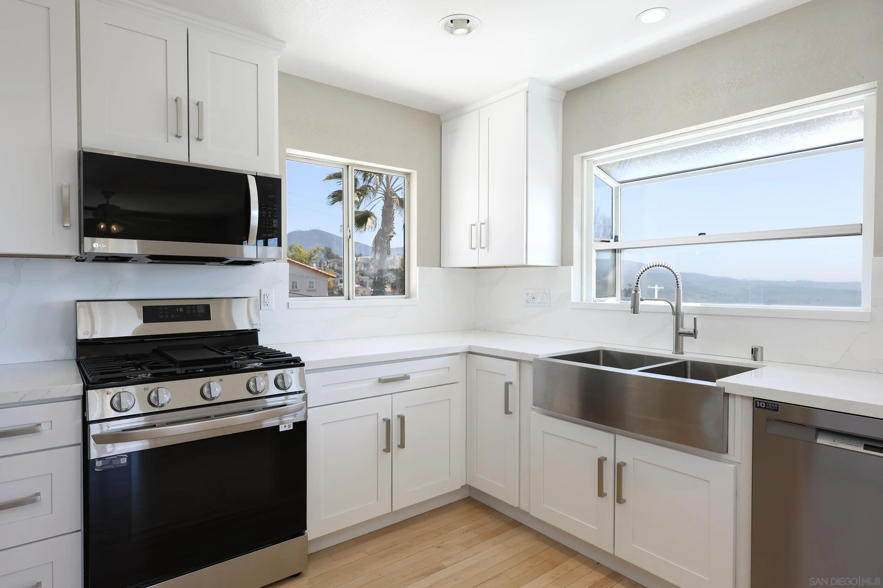 1412 San Miguel Avenue Spring Valley, CA 91977 - Photo 15 of 44 a kitchen with white cabinets and stainless steel appliances