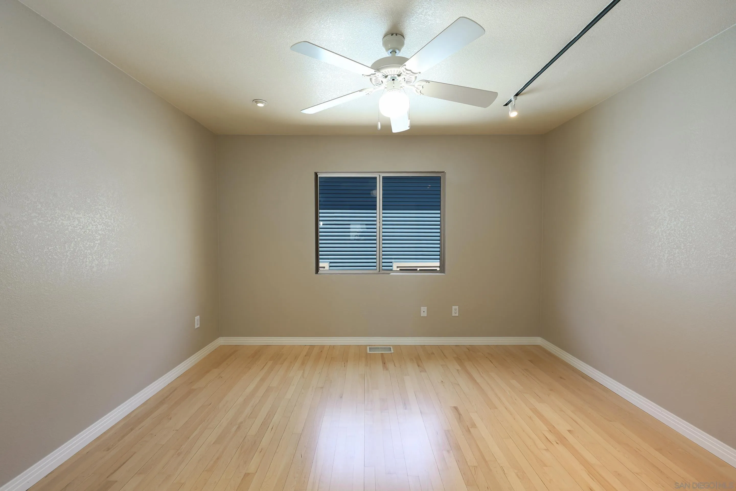 1412 San Miguel Avenue Spring Valley, CA 91977 - Photo 22 of 44 an empty room with wooden floor and windows