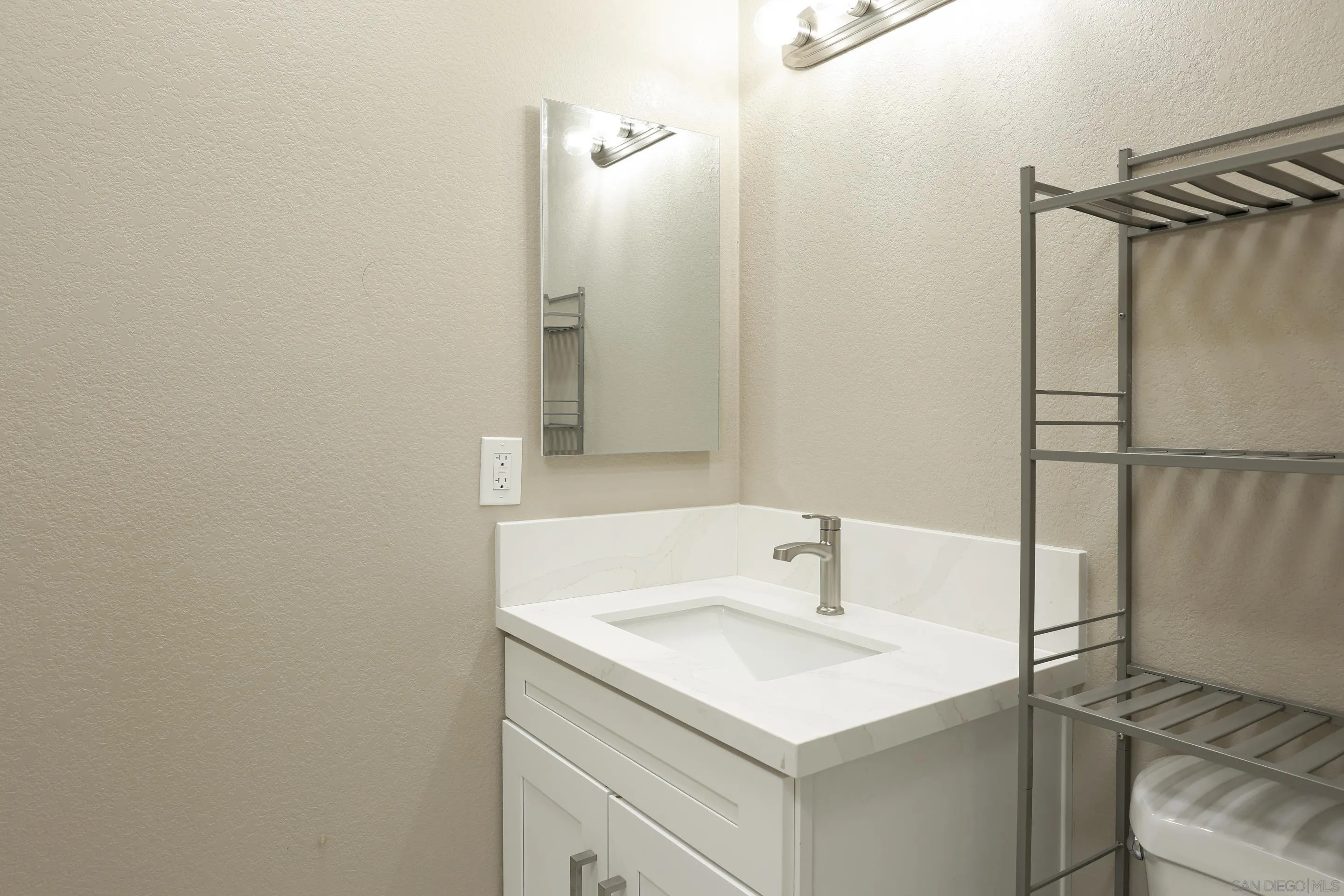 1412 San Miguel Avenue Spring Valley, CA 91977 - Photo 23 of 44 a bathroom with a sink and a mirror