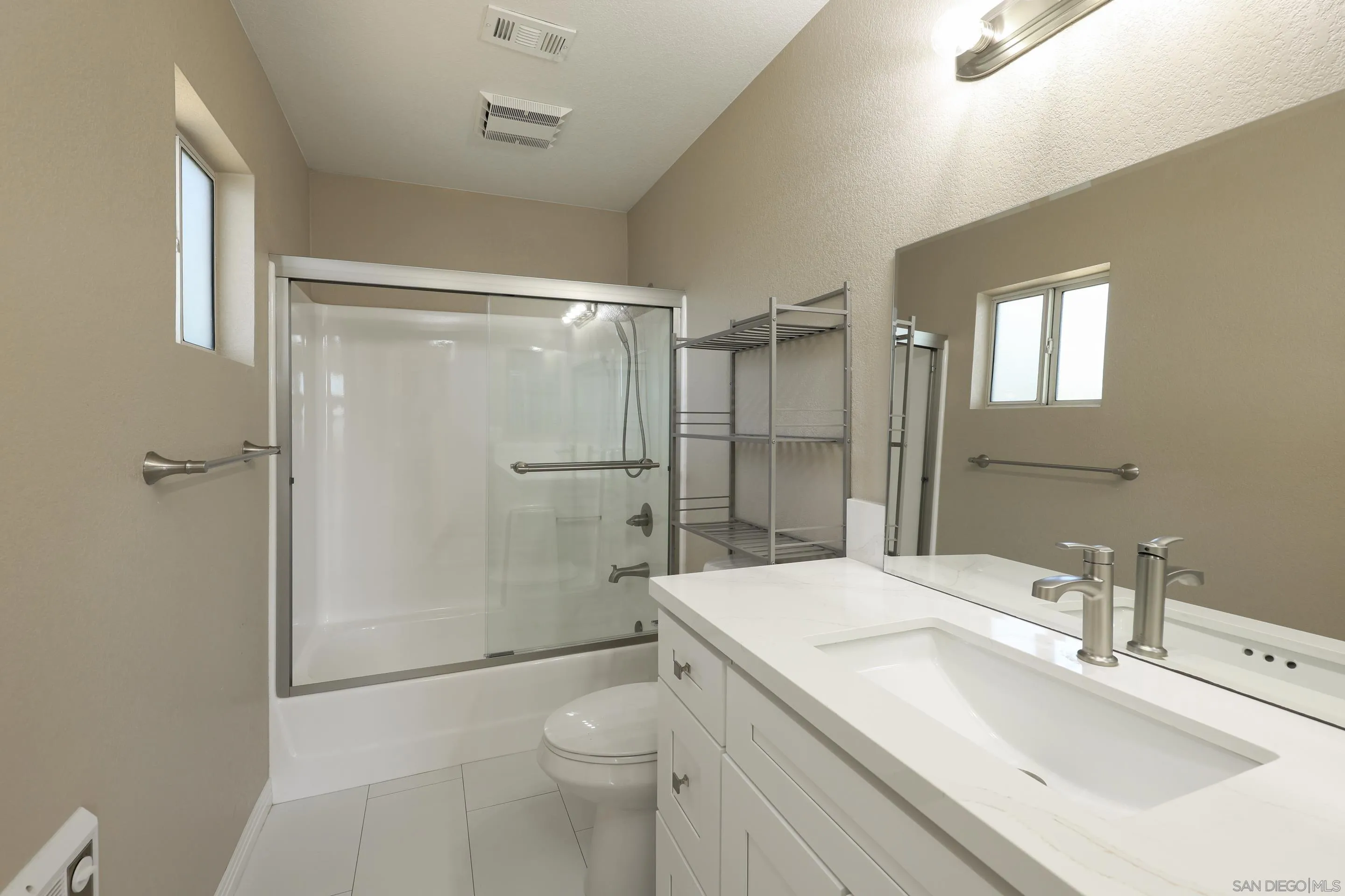 1412 San Miguel Avenue Spring Valley, CA 91977 - Photo 26 of 44 a bathroom with a sink a toilet and shower