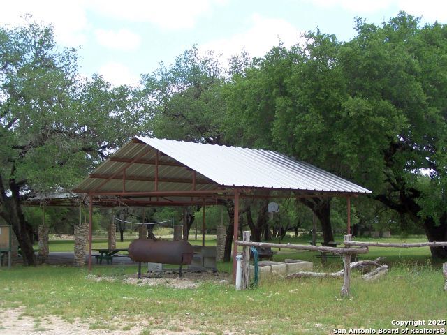 62 Turkey Trot Uvalde, TX 78801 - Photo 39 of 39 a view of backyard with table and chairs under an umbrella