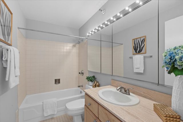 a bathroom with a sink toilet a mirror and shower