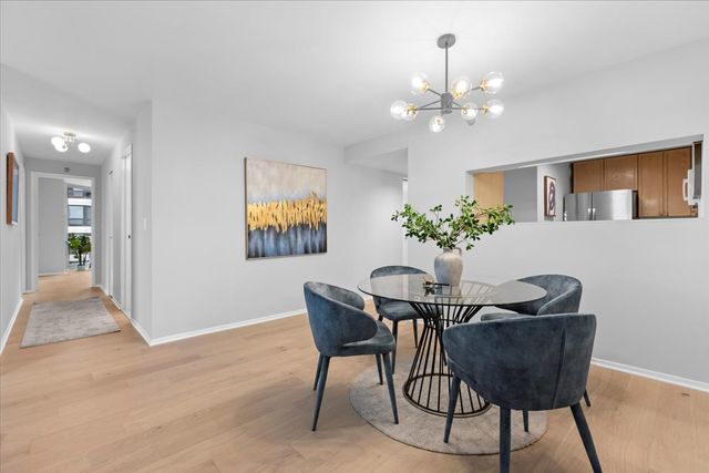 a dining room with furniture and chandelier