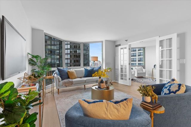a living room with furniture and a potted plant
