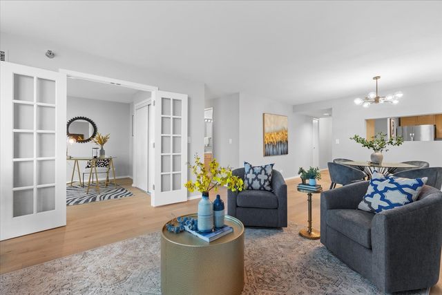 a living room with furniture and a potted plant
